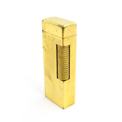 1434 - A cased Dunhill Rollagas pocket lighter, with chequered finish, approx 2 1/2