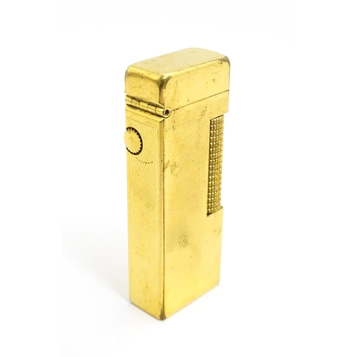 1434 - A cased Dunhill Rollagas pocket lighter, with chequered finish, approx 2 1/2