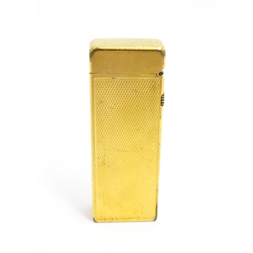 1434 - A cased Dunhill Rollagas pocket lighter, with chequered finish, approx 2 1/2