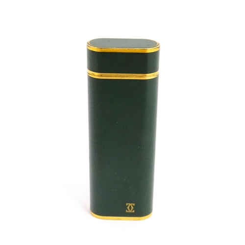 1436 - A Cartier Paris pocket lighter, with gold plated and green enamel finish, serial number 96709E, with... 