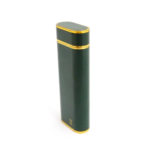 1436 - A Cartier Paris pocket lighter, with gold plated and green enamel finish, serial number 96709E, with... 