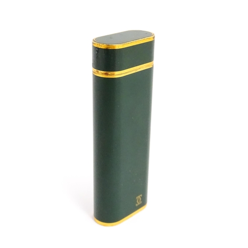 1436 - A Cartier Paris pocket lighter, with gold plated and green enamel finish, serial number 96709E, with... 