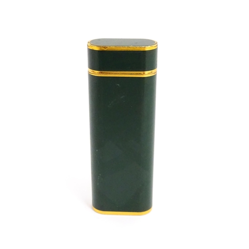 1436 - A Cartier Paris pocket lighter, with gold plated and green enamel finish, serial number 96709E, with... 