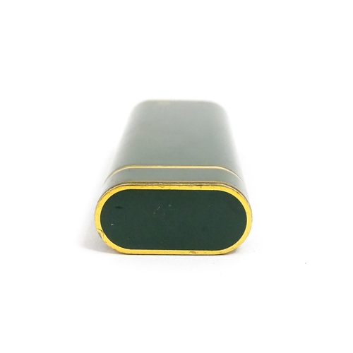 1436 - A Cartier Paris pocket lighter, with gold plated and green enamel finish, serial number 96709E, with... 