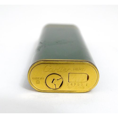 1436 - A Cartier Paris pocket lighter, with gold plated and green enamel finish, serial number 96709E, with... 