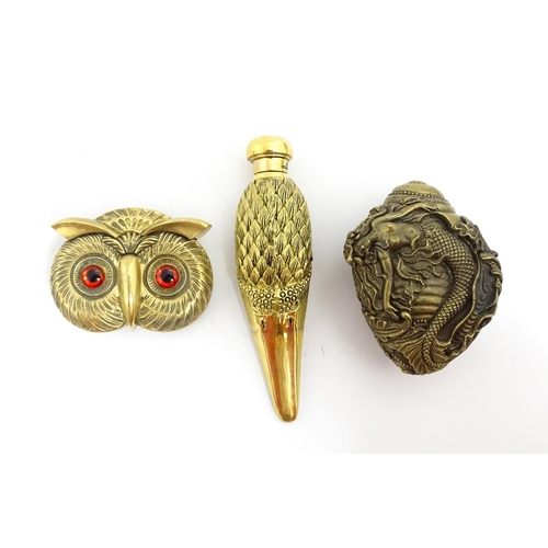 1439 - Two late 20thC novelty vesta cases comprising one modelled as the head of an owl, the other of shape... 