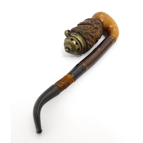 1440 - An early to mid 20thC carved Tyrolean pipe, the walnut and briar bowl with white metal cap and decor... 