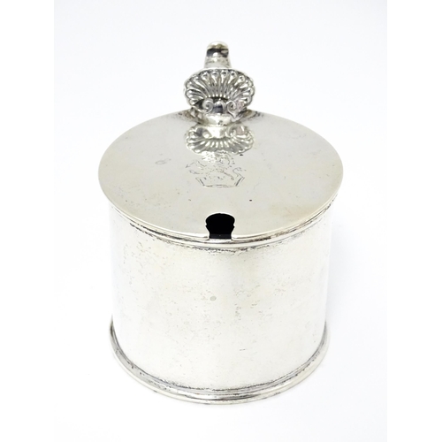 385A - A Victorian silver mustard pot with blue glass liner, hinged lid and engraved armorial to top, hallm... 