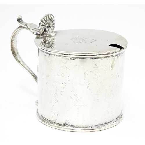 385A - A Victorian silver mustard pot with blue glass liner, hinged lid and engraved armorial to top, hallm... 