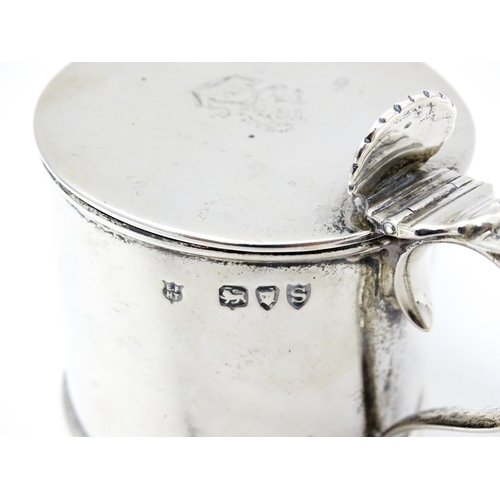 385A - A Victorian silver mustard pot with blue glass liner, hinged lid and engraved armorial to top, hallm... 