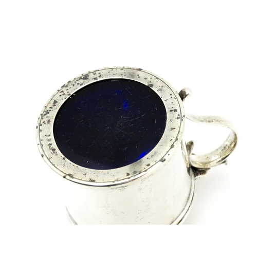 385A - A Victorian silver mustard pot with blue glass liner, hinged lid and engraved armorial to top, hallm... 