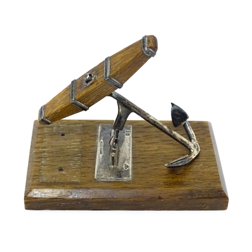 390A - A Victorian novelty letter clip formed as a silver anchor on an oak base, hallmarked London 1901, ma... 