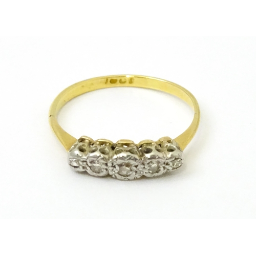 732 - An 18ct gold set with five illusion set diamonds. Ring size approx. L