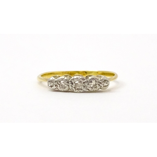 732 - An 18ct gold set with five illusion set diamonds. Ring size approx. L