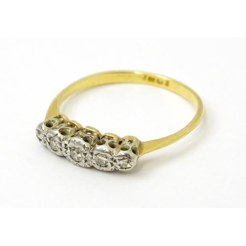 732 - An 18ct gold set with five illusion set diamonds. Ring size approx. L