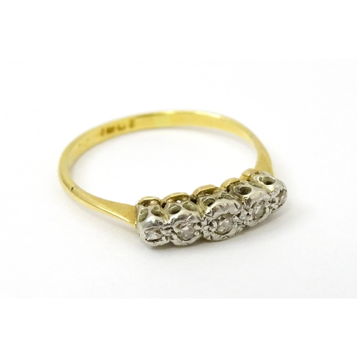 732 - An 18ct gold set with five illusion set diamonds. Ring size approx. L