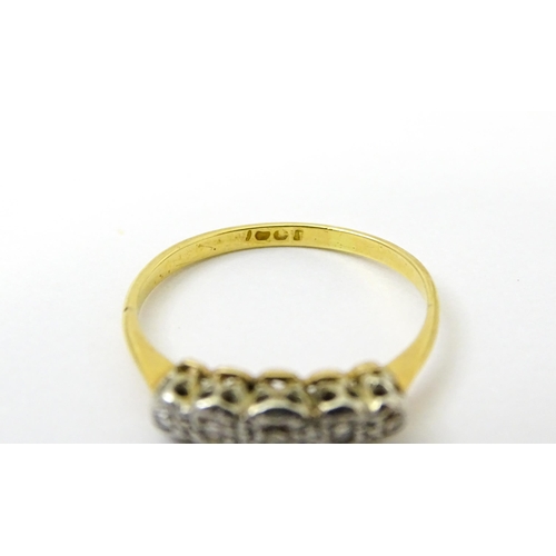 732 - An 18ct gold set with five illusion set diamonds. Ring size approx. L