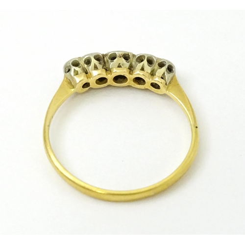 732 - An 18ct gold set with five illusion set diamonds. Ring size approx. L