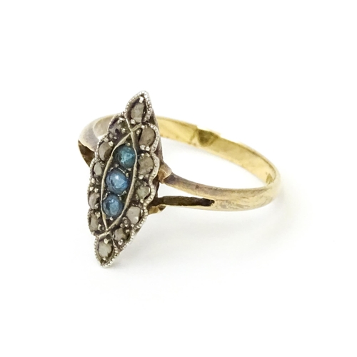 735 - A late 19thC / early 20thC 18ct gold ring set with three blue stones bordered by diamonds. Ring size... 