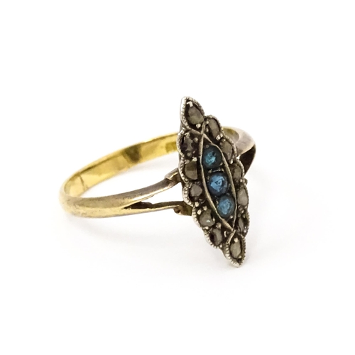 735 - A late 19thC / early 20thC 18ct gold ring set with three blue stones bordered by diamonds. Ring size... 