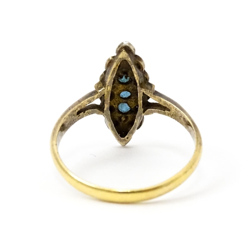 735 - A late 19thC / early 20thC 18ct gold ring set with three blue stones bordered by diamonds. Ring size... 