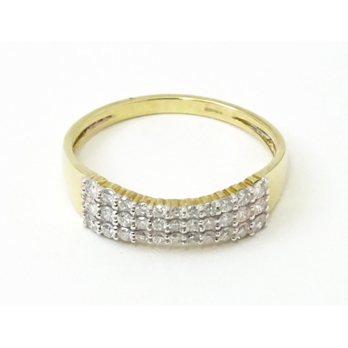 736 - A 9ct gold ring set with three bands of diamonds. Ring size approx. R 1/2