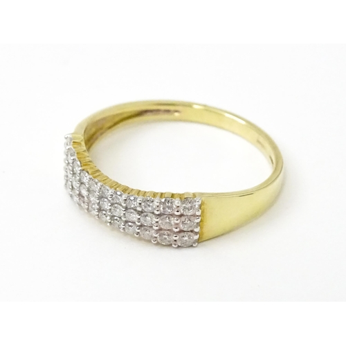 736 - A 9ct gold ring set with three bands of diamonds. Ring size approx. R 1/2