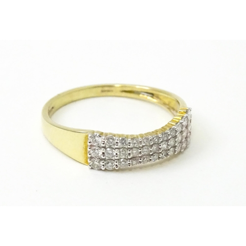 736 - A 9ct gold ring set with three bands of diamonds. Ring size approx. R 1/2