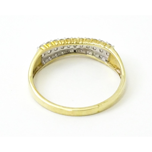 736 - A 9ct gold ring set with three bands of diamonds. Ring size approx. R 1/2