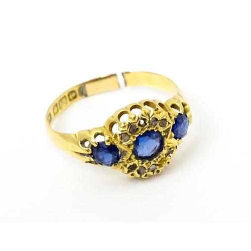 743 - A late 19thC 18ct gold ring set with sapphires and diamonds. Ring size approx.  N. (approx 2.2g)