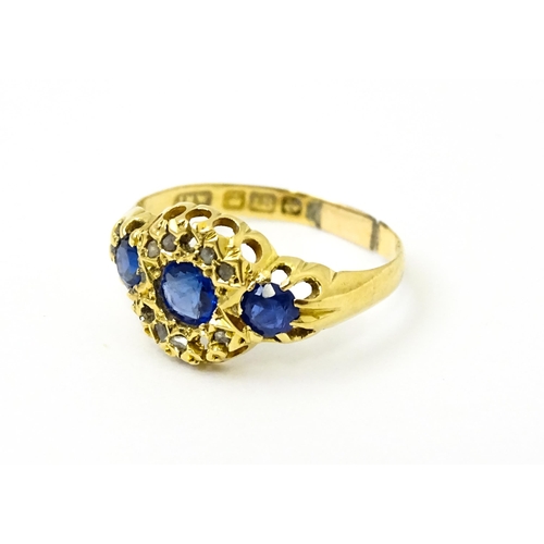 743 - A late 19thC 18ct gold ring set with sapphires and diamonds. Ring size approx.  N. (approx 2.2g)