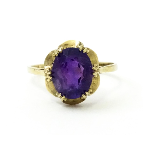 745 - A 9ct gold dress ring set with amethyst. Ring size approx. M 1/2