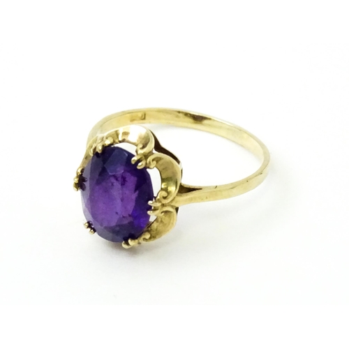 745 - A 9ct gold dress ring set with amethyst. Ring size approx. M 1/2