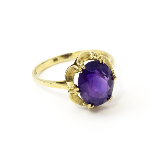 745 - A 9ct gold dress ring set with amethyst. Ring size approx. M 1/2