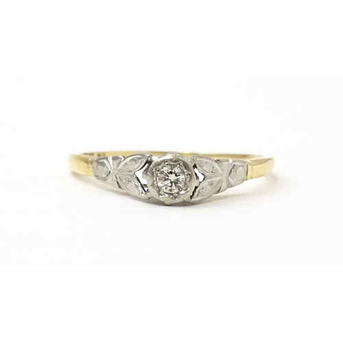 746 - An 18ct gold ring with central platinum set brilliant cut diamond. Ring size approx. O 1/2