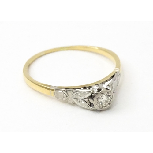 746 - An 18ct gold ring with central platinum set brilliant cut diamond. Ring size approx. O 1/2