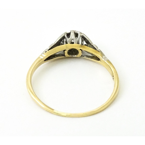 746 - An 18ct gold ring with central platinum set brilliant cut diamond. Ring size approx. O 1/2