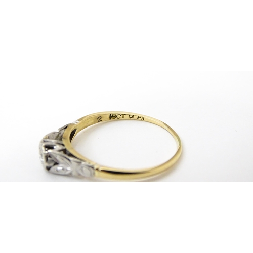 746 - An 18ct gold ring with central platinum set brilliant cut diamond. Ring size approx. O 1/2