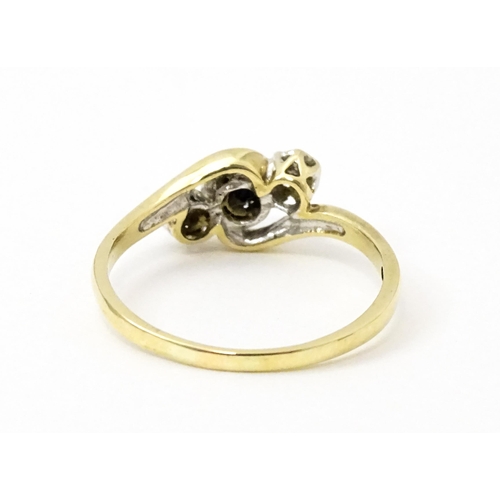 749 - A 9ct gold ring set with central sapphire flanked by diamonds. Ring size approx. Q 1/2