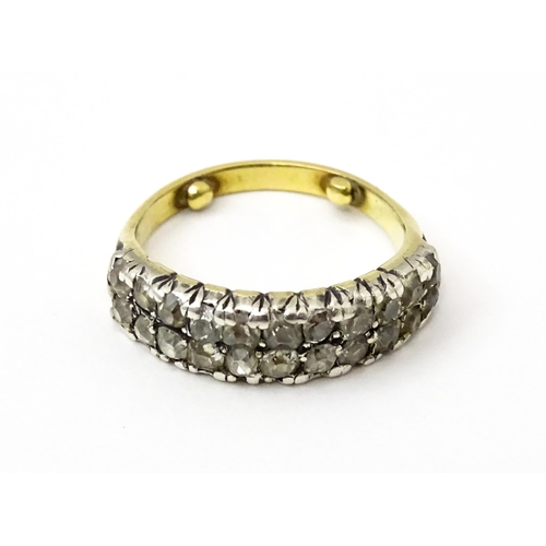 756 - A late 19thC / early 20thC gold half eternity ring set with two bands each with eleven diamonds. Rin... 