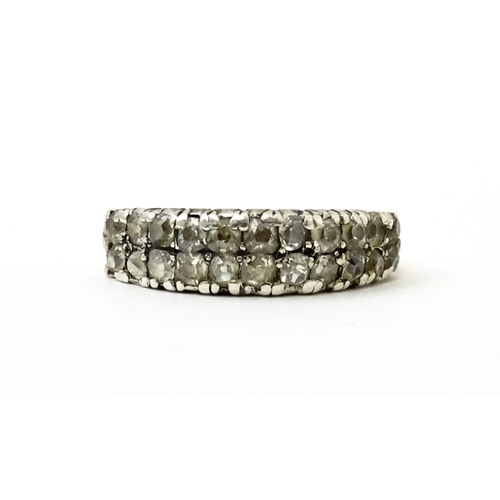 756 - A late 19thC / early 20thC gold half eternity ring set with two bands each with eleven diamonds. Rin... 