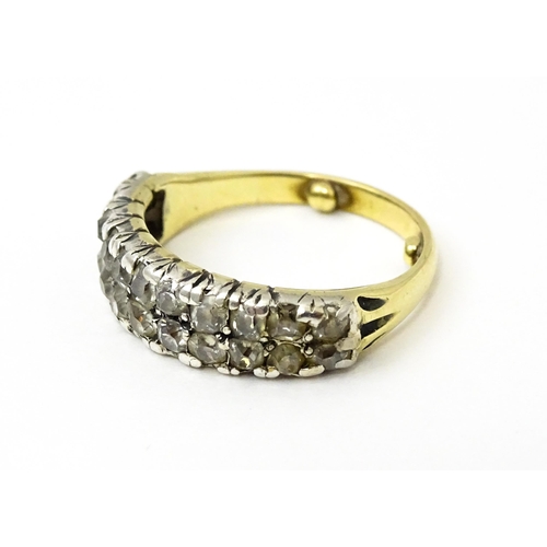 756 - A late 19thC / early 20thC gold half eternity ring set with two bands each with eleven diamonds. Rin... 