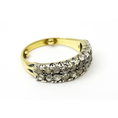 756 - A late 19thC / early 20thC gold half eternity ring set with two bands each with eleven diamonds. Rin... 