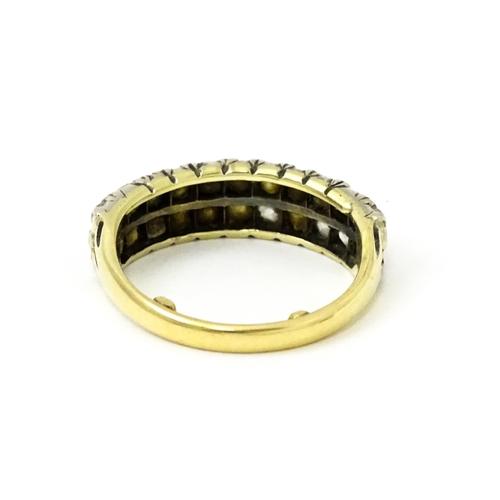 756 - A late 19thC / early 20thC gold half eternity ring set with two bands each with eleven diamonds. Rin... 