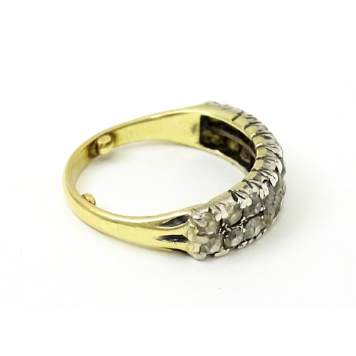 756 - A late 19thC / early 20thC gold half eternity ring set with two bands each with eleven diamonds. Rin... 