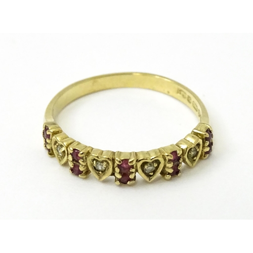 760 - A 9ct gold ring set with diamonds and rubies with heart detail. Ring size approx. P 1/2