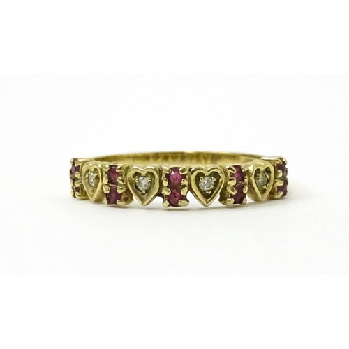 760 - A 9ct gold ring set with diamonds and rubies with heart detail. Ring size approx. P 1/2