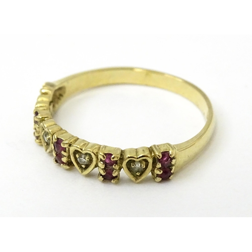 760 - A 9ct gold ring set with diamonds and rubies with heart detail. Ring size approx. P 1/2