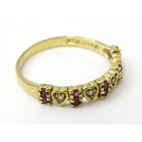 760 - A 9ct gold ring set with diamonds and rubies with heart detail. Ring size approx. P 1/2