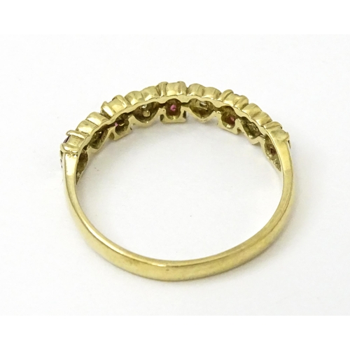 760 - A 9ct gold ring set with diamonds and rubies with heart detail. Ring size approx. P 1/2